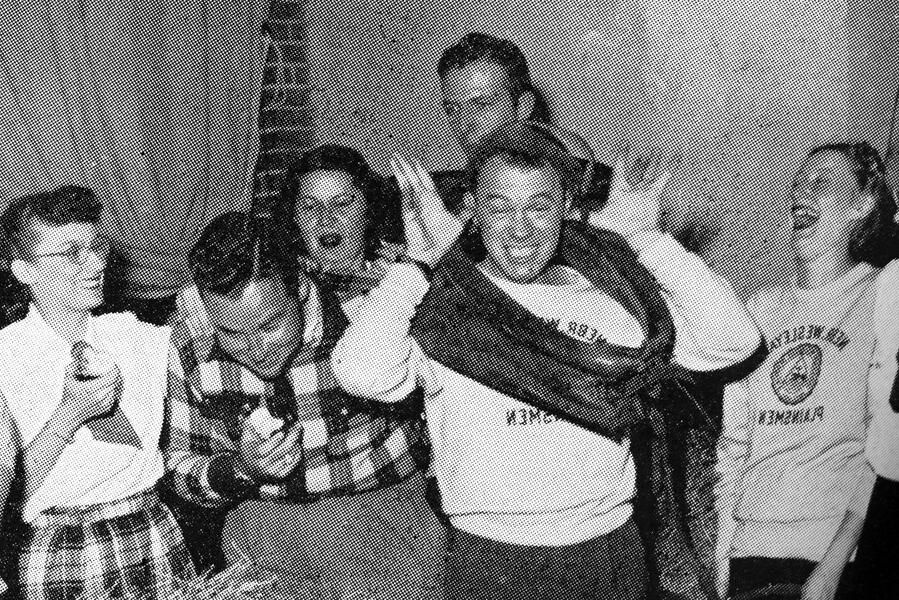 Students from 1940 laughing and acting silly in this old yearbook photo.